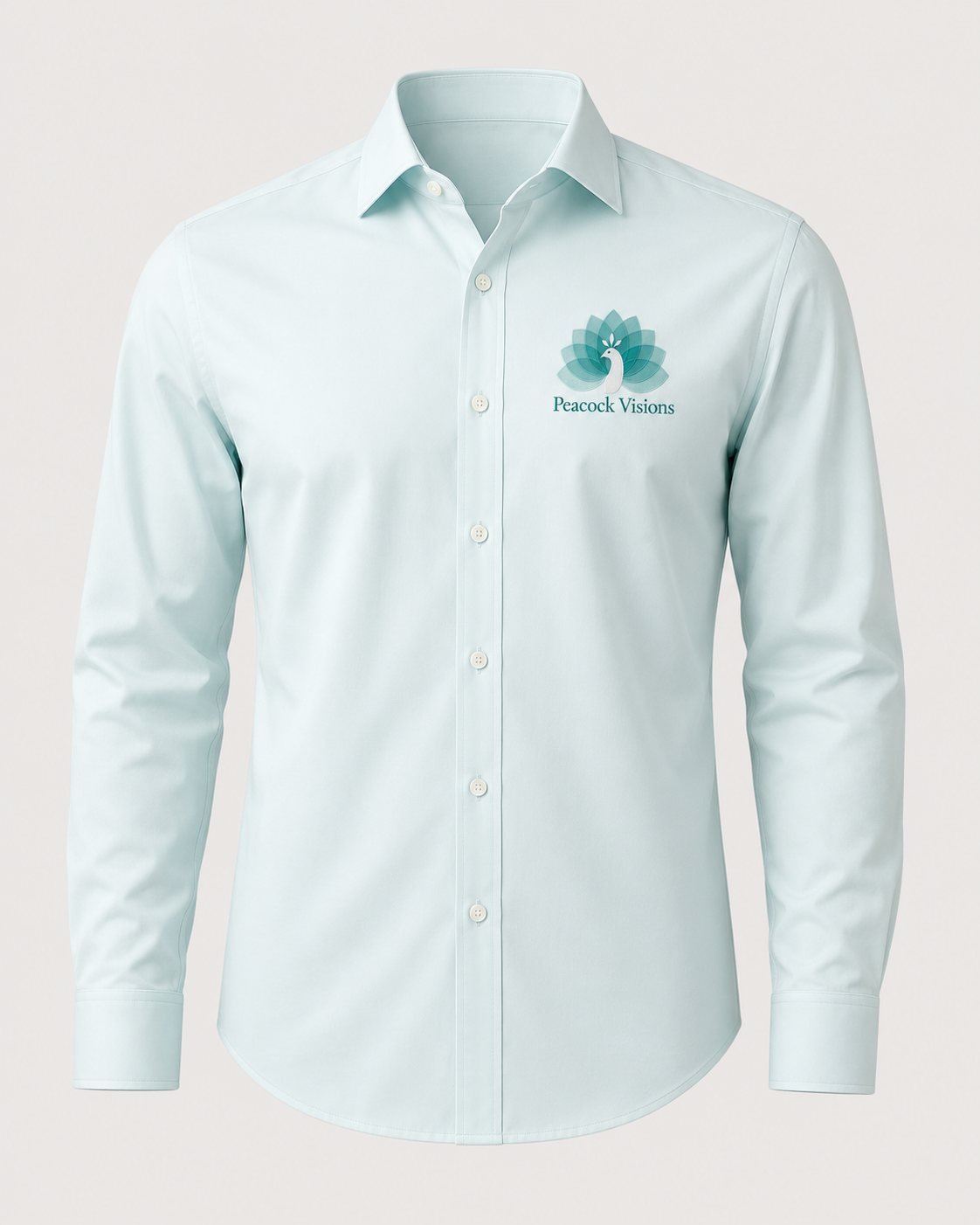 Pale mint shirt embroidered with the Peacock Visions lotus peacock logo and wordmark